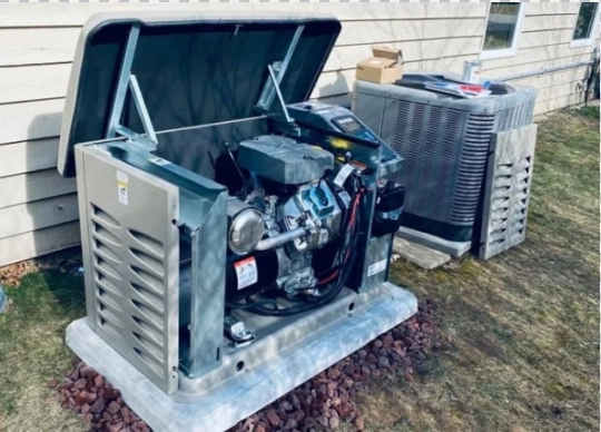 Residential generator with an open lid next to an air conditioning unit.