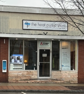 Exterior view of The Heat Pump Store with a sign and display window.