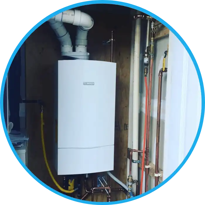 imgpsh_fullsize_anim-6 Bosch condensing boiler installed in a utility room with pipes and fittings.